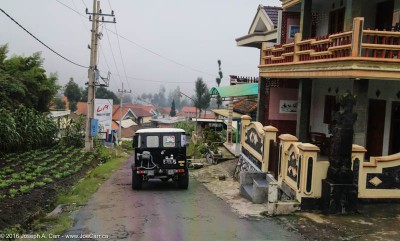 Jeeps descending through a village near Mt. Bromo, Java, Indonesia