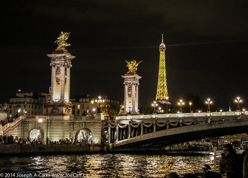 The Eiffel Tower and Pont de la Concorde towers lit at night