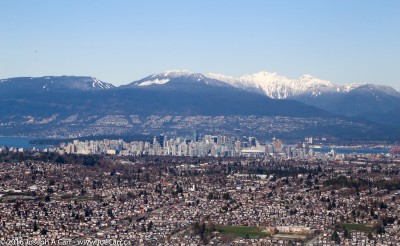 Looking North across the city of Vancouver to the North Shore mountains on final approach to Vancouver airport